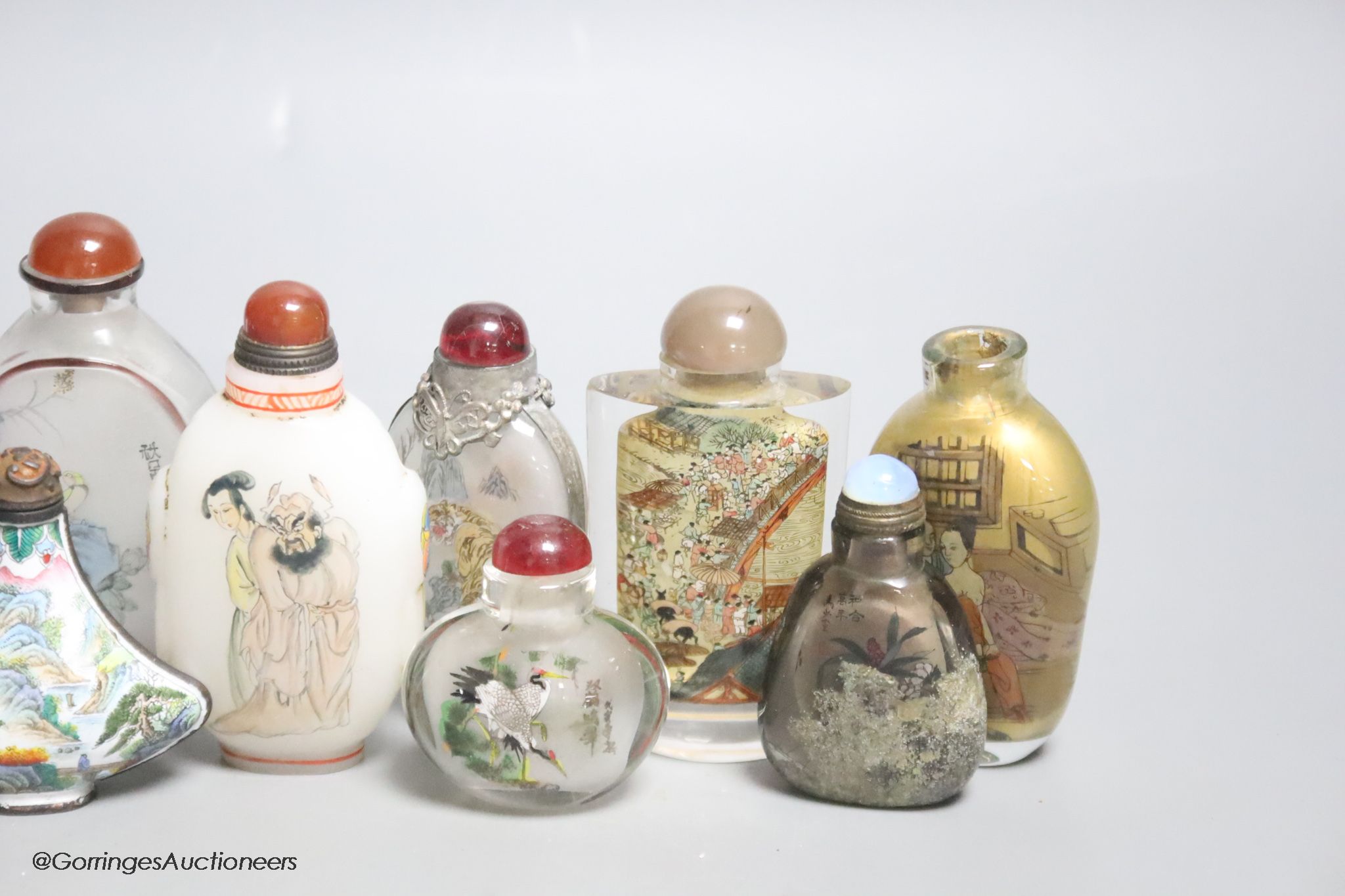 Eleven Chinese painted glass snuff bottles, a glass enamel one and another enamel one